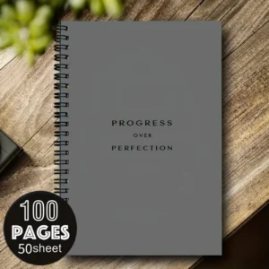 Cuaderno de espiral A5 gris con la frase Progress over perfection